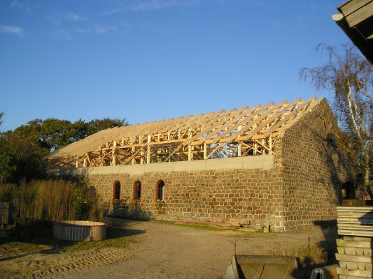 An old barn is being transformed into a house